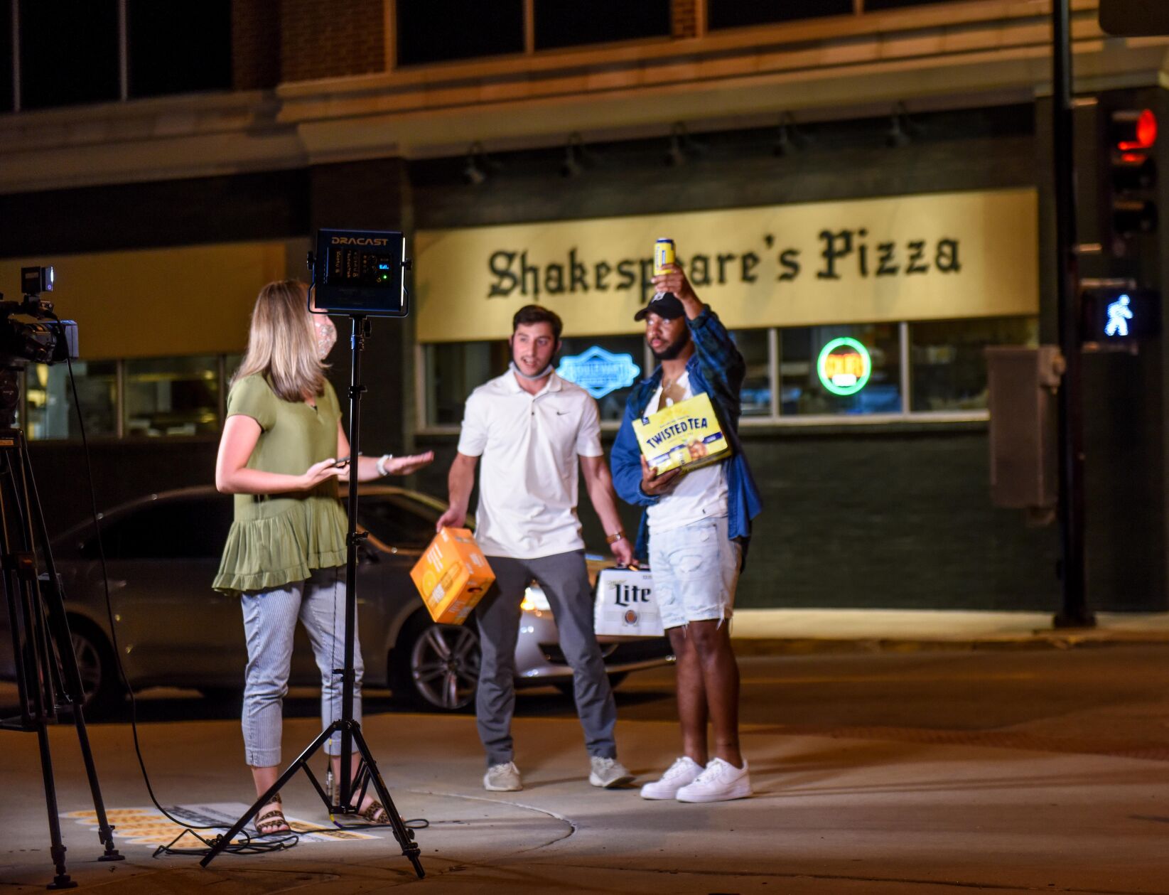 Two men yell at KOMU reporter Sara Moyers, interrupting her reporting